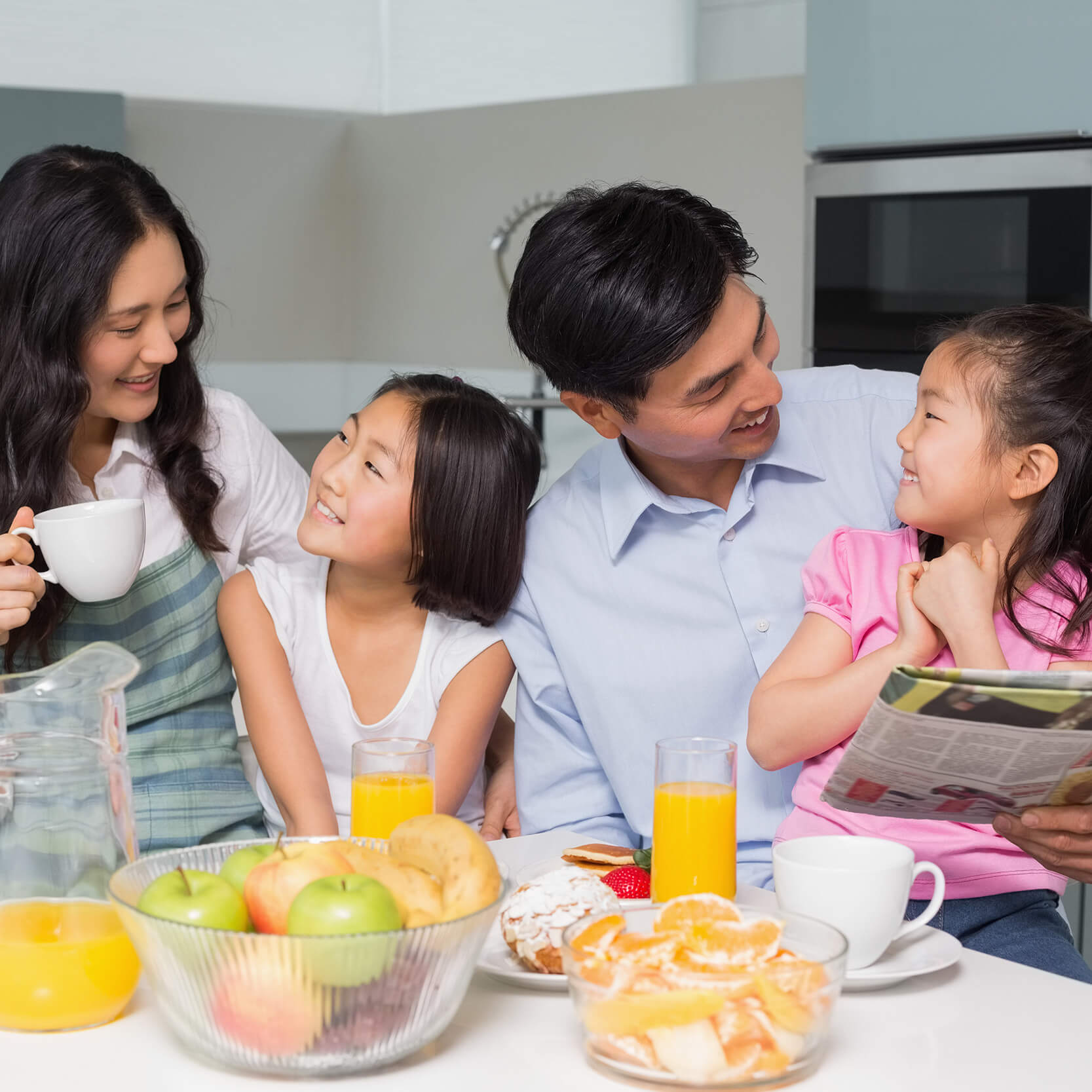 parents with their 2 kids at kitchen table