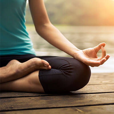 crossed legs of lady practicing yoga