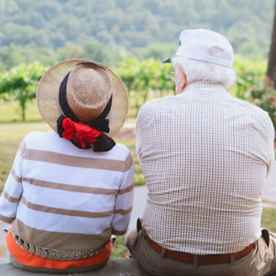 Elderly couple sitting outside