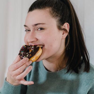 Young women eating a donut