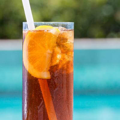 iced tea glass in front of a pool