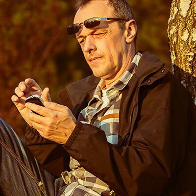 Man sitting outside with smartphone